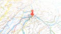 A red pin stuck in Bern on a map of Switzerland