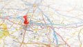 A red pin stuck in Charleroi on a map of Belgium