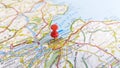 A red pin stuck in Edinburgh on a map of Scotland