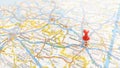 A red pin stuck in Eindhoven on a map of Belgium