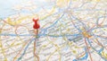 A red pin stuck in Gent on a map of Belgium