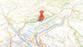 A red pin stuck in Lake Garda on a map of Italy