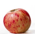 Red-pink apple on a light background. Isolated object