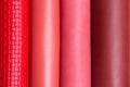 Red, pink, brown vertical leather rolls for background. Royalty Free Stock Photo