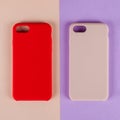 Red and pink cell phone cases on paper background Royalty Free Stock Photo