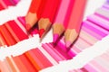 Red and pink colored pencils and color chart of all colors Royalty Free Stock Photo