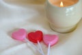 Red and Pink heart shaped lollipops with candle Royalty Free Stock Photo