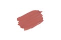 Red-pink isolated Swatch of lipstick on a white background. A smear of makeup. The base for makeup has a creamy texture