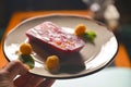 Red and pink layers of gelatin dessert served on a white plate. Tasty sweet dish, fruit jello dessert.