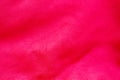 Red pink leather surface under high magnification close detail photography with patterns and surface texture background