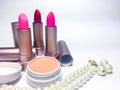 Red and pink moisturizer lipstick in pearl gold