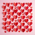 Red and pink paper hearts arranged in a grid pattern on a light pink background. The Royalty Free Stock Photo