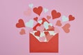 Red and pink paper hearts in an red envelope on pink Royalty Free Stock Photo