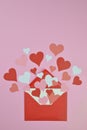 Red and pink paper hearts in an red envelope on pink Royalty Free Stock Photo