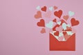 Red and pink paper hearts in an red envelope on pink Royalty Free Stock Photo