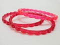 Red and pink plastic bangles isolated on white background, beautiful fashion accessory Royalty Free Stock Photo