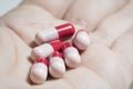 Red and pink probiotics capsule on palm Royalty Free Stock Photo