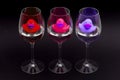 Red, pink and purple rubber ducks in wineglasses