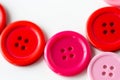 Red and pink sewing buttons on white background Royalty Free Stock Photo