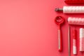 Red pink sewing tools and thread spools on pink background Royalty Free Stock Photo