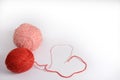 Red and pink tangle of knitting threads on a white background