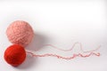 Red and pink tangle of knitting threads on a white background