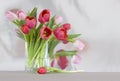 Red and pink tulips in a vase - shiny reflective b