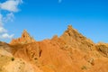 Red pinnacles of sandstone rocks at rainbow mountain canyon