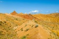 Red pinnacles of sandstone rocks at rainbow mountain canyon