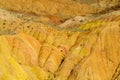 Red pinnacles of sandstone rocks at rainbow mountain canyon