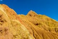 Red pinnacles of sandstone rocks at rainbow mountain canyon