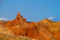 Red pinnacles of sandstone rocks at rainbow mountain canyon