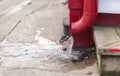 Red pipe and spout with frozen water in city streets Royalty Free Stock Photo