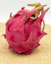 Red pitaya fruit. Red dragon fruit on a jute fabric, on a white background Royalty Free Stock Photo