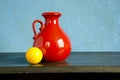 Red pitcher and yellow billiards ball Royalty Free Stock Photo