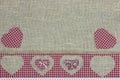 Red plaid country border with hearts on shabby burlap background