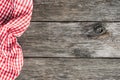 Red plaid kitchen textile on old wooden background