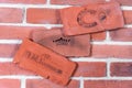 Red plaster decorative tile based on casts of old bricks with horseshoe sign, serial number and name stamp, top view