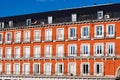 Red Plaster Facade of Old Building with Windows and Balconie Royalty Free Stock Photo