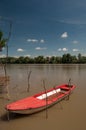 Red plastic boat floating on the river