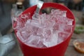 Red plastic bucket with ice cubes Royalty Free Stock Photo