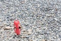 Red plastic buoyancy aid in the sand on lonely beach.