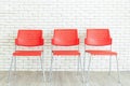 Red plastic chairs are available to allow applicants to sit and wait for a job interview
