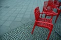 Red plastic chairs at streetside cafe Royalty Free Stock Photo