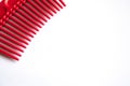 Red plastic comb on a white background Royalty Free Stock Photo