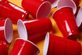 Red plastic cups for beer pong game on orange background, closeup Royalty Free Stock Photo