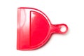 Red plastic dust shovel on white background Royalty Free Stock Photo