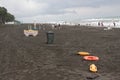 Red plastic floatation rescue devices and sunbeds on beach. cloudy weather, overcast