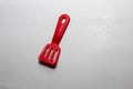 Red plastic food ladle - kids toys Royalty Free Stock Photo