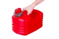 Red plastic fuel canister in hand isolated Royalty Free Stock Photo